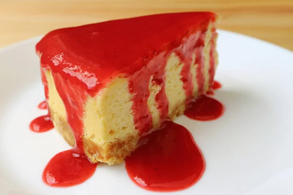 Closed Baked Cheesecake Vibrant Red Raspberry Sauce Served White Plate — Stock Photo, Image