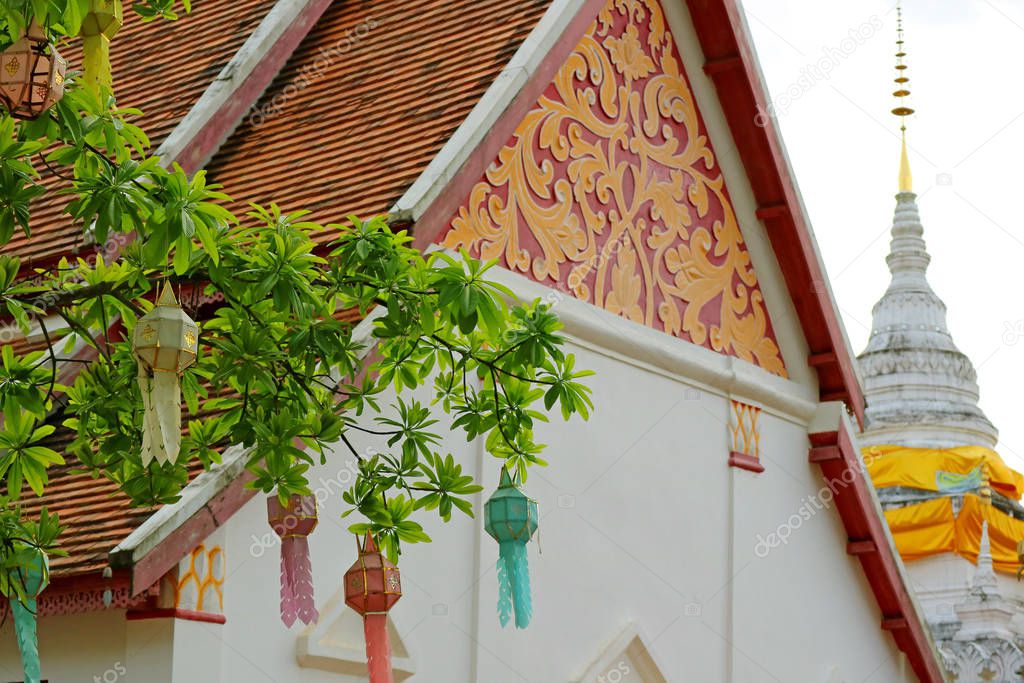 Decorated Tympanum and White Chedi (Stupa) of Wat Phra That Khao Noi Temple, Historic Place in Nan Province, Thailand