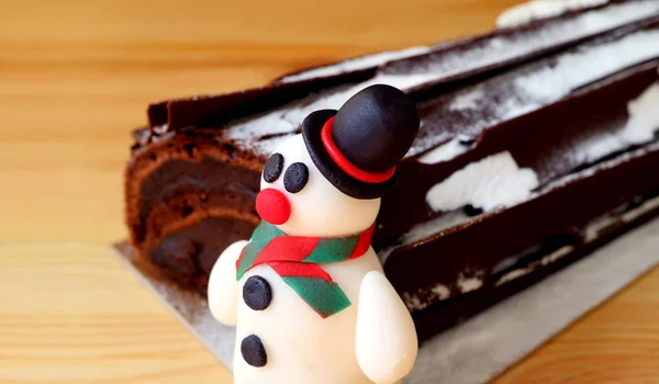 Close Cute Snowman Marzipan Blurred Chocolate Yule Log Cake Background — Stock Photo, Image