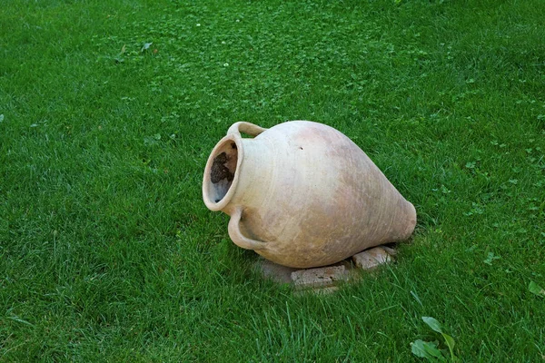 Ancient Style Armenian Wine Jar Isolated on Vibrant Green Lawn