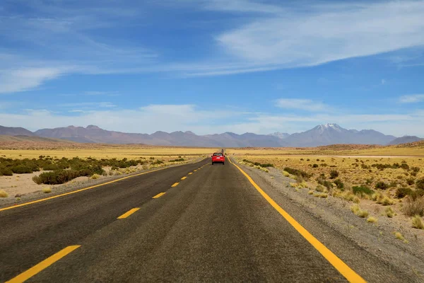 Driving on the high altitude desert road of Atacama desert in northern Chile, South America