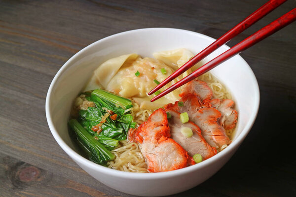 Popular Asian Dish of Roasted Pork Wonton Dumpling and Egg Noodle Soup with Vegetables