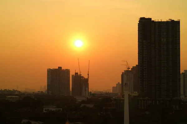 Oslnivé Večerní Slunce Zlaté Obloze Nad Siluetou Městského Staveniště — Stock fotografie