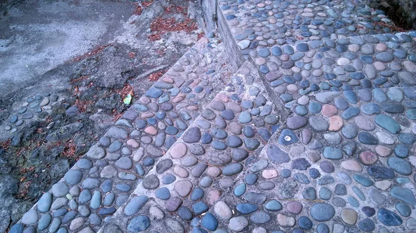 round stones lined road, wall background