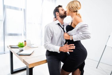 Sexy secretary tempting businessman at office table clipart