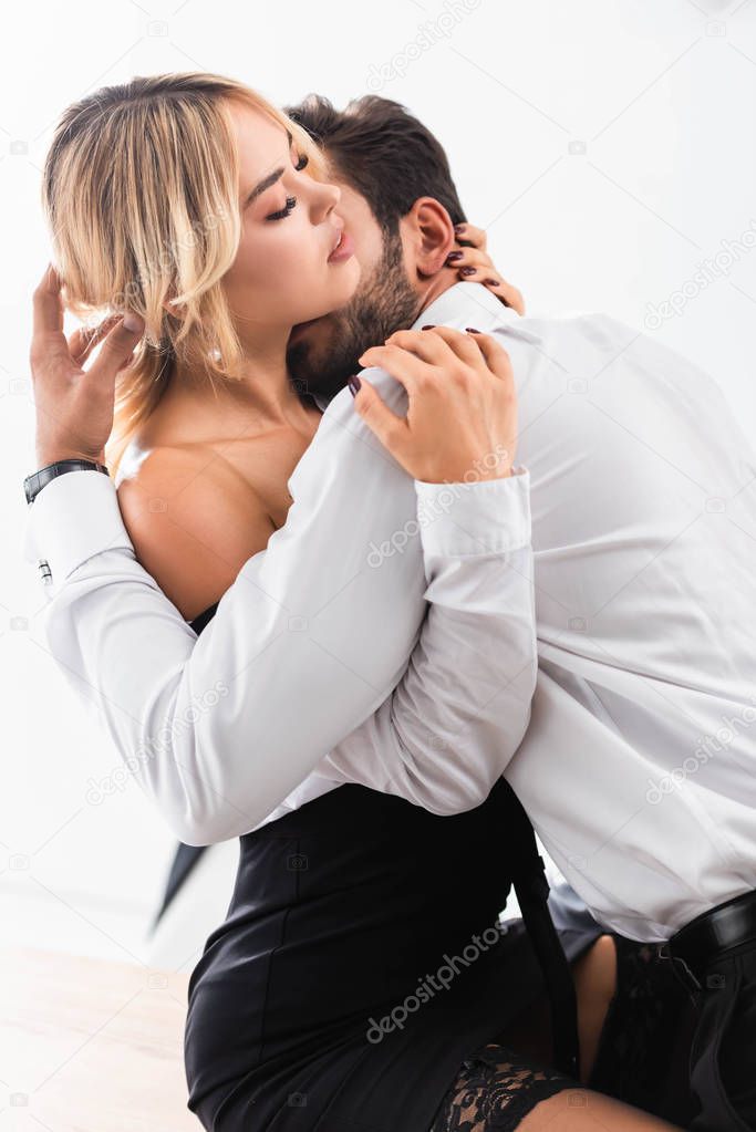 Businessman hugging and kissing sexy secretary on office table