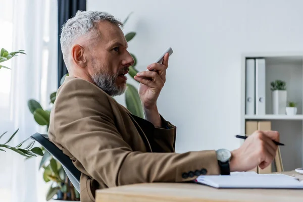 Side View Bearded Businessman Recording Voice Message While Holding Smartphone — Stock Photo, Image