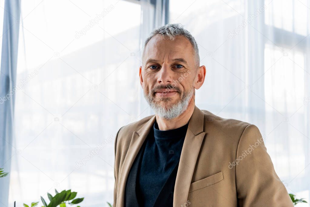 happy businessman smiling while looking at camera 