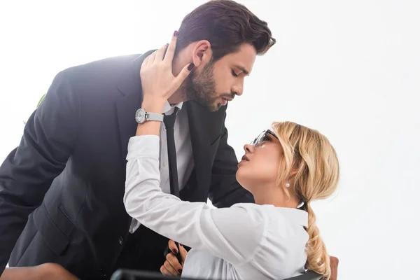 Sexy businesswoman pulling tie of businessman in office — Stock Photo