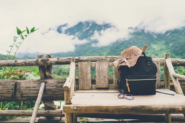 Travel backpack on the wooden bench with landscape — Stock Photo, Image