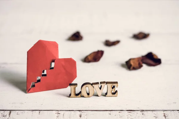 Red broken heart with dried rose petal — Stock Photo, Image