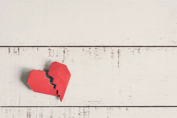 Red broken heart on white wooden background — Stock Photo, Image