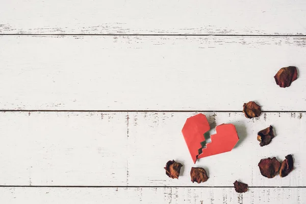 Red broken heart with dried rose petal — Stock Photo, Image