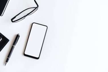 Boş ekran Akıllı telefon ve dosya klasörünü kopyalama alanı ve üst görünümü olan ofis masasına bırak
