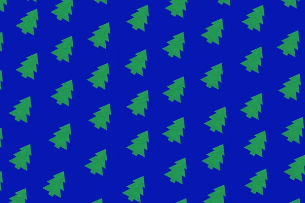 Pattern composition of green Christmas trees on blue background.