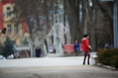 Arka plan bulanık. Şehrin sokaklarında insanlar.