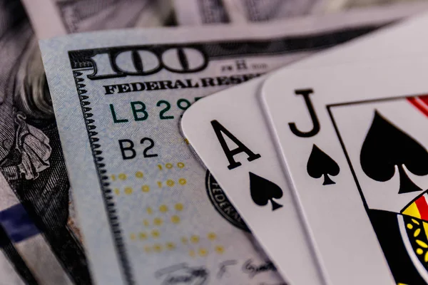 Primer plano de una mano de Blackjack 21 sobre una cama de billetes de cien dólares (SHALLOW) II — Foto de Stock