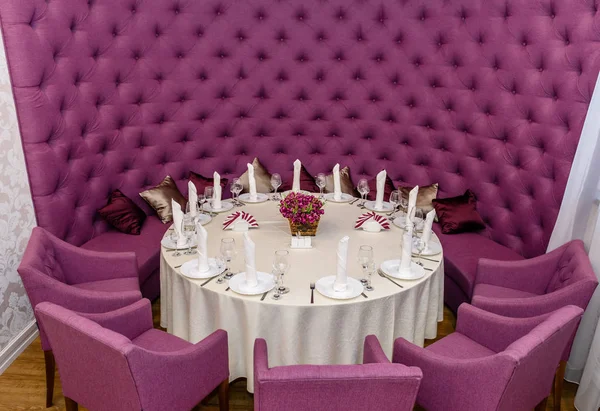 Decorado com uma mesa redonda com poltronas roxas Fotografias De Stock Royalty-Free