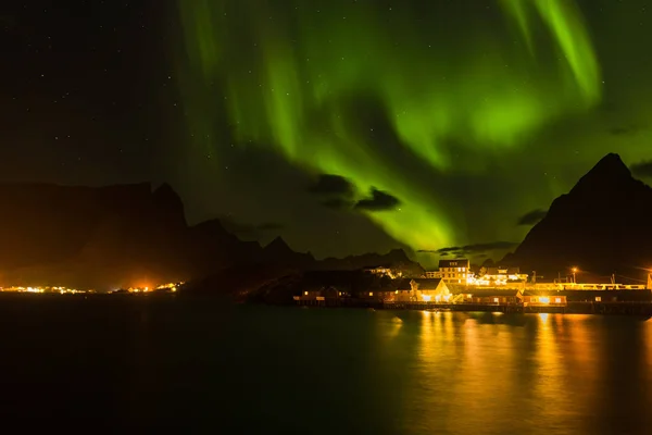 Dramatic aurora borealis, polar lights, over mountains in the North of Europe - Lofoten islands, Norway