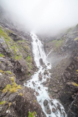 Waterfall and bridge on the Norwegian Scenic Route Geiranger - Trollstigen in Sunnmore region, More og Romsdal, Norway