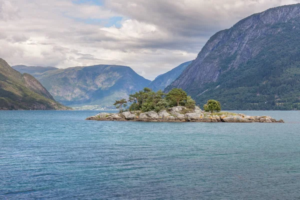 Norwegian fjord and mountains surrounded by clouds, ideal fjord reflection in clear water. selective focus. — Stock Photo, Image