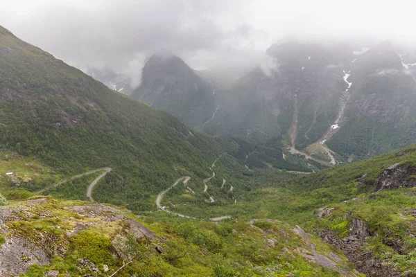 Estrada serpentina nas montanhas da Noruega, escadaria do troll, clima sombrio sombrio, asfalto úmido, foco seletivo — Fotografia de Stock