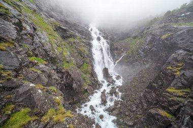 Waterfall and bridge on the Norwegian Scenic Route Geiranger - Trollstigen in Sunnmore region, More og Romsdal, Norway.