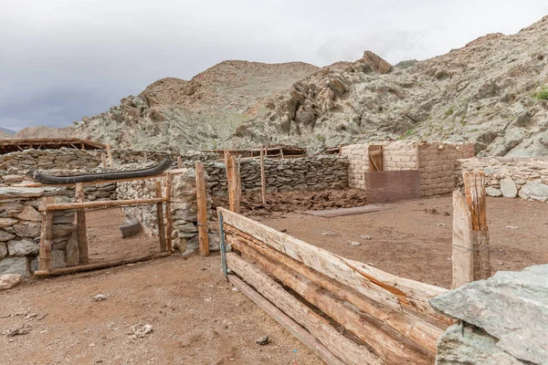 Corral near winter dwelling of the nomadic people on the hills of Mongolia. Altai