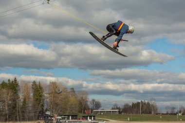 Fagersta, İsveç - Maj 01, 2020: İnsanoğlu wakeboard 'a aşırı atlıyor, etrafta bir sürü sıçrama oluyor