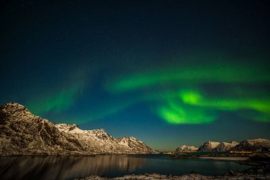 güzel kuzey ışıkları, Aurora borealis fiyort dağları üzerinde gökyüzünde birçok yıldız Lofoten adalarında, Norveç, uzun kepenk hızı.