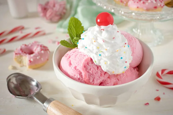 Food photography of an 50's style retro diner bowl of peppermint ice cream with whipped cream and pastel colors