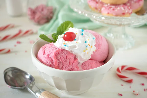 Food photography of an 50\'s style retro diner bowl of peppermint ice cream with whipped cream and pastel colors