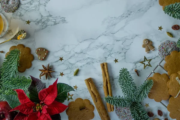 Food photography of christmas cookies and hot apple cider on a marble table