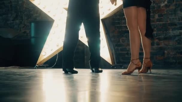 Close-up of the legs of a man and a woman dancing a pair of ballroom dance in the room. Dance moves of the tango. — 비디오