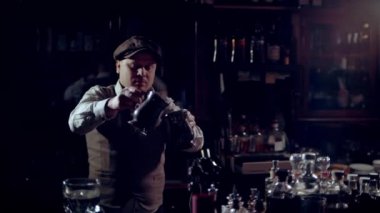 Cooking a burning punch or grog in a bar. A fiery stream pours from cup to cup. Speakeasy style bar. The footage is recorded at 60 frames per second, and you can slow it down. 