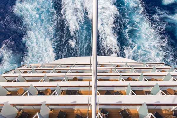 Balconies on a backof Cruise ship, decks with wake or trail on ocean surface