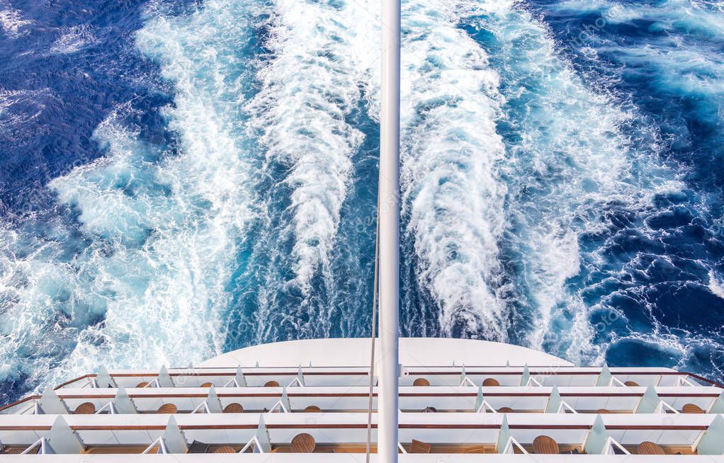 Balconies on a backof Cruise ship, decks with wake or trail on ocean surface