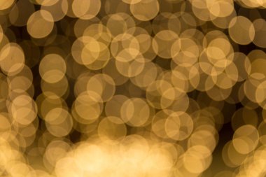 Bokeh odaklı ışıklarla altın soyut arkaplan