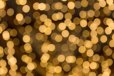 Bokeh odaklı ışıklarla altın soyut arkaplan