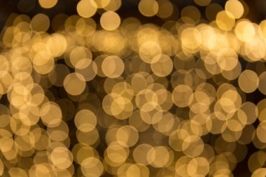 Bokeh odaklı ışıklarla altın soyut arkaplan