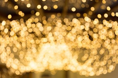 Bokeh odaklı ışıklarla altın soyut arkaplan