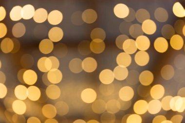 Bokeh odaklı ışıklarla altın soyut arkaplan
