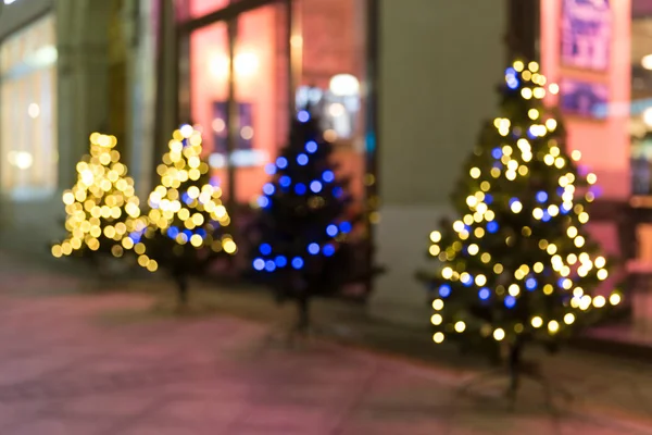 Christmas trees on street blurry background with bokeh