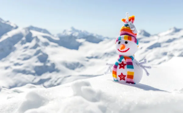 Happy snowman in mountains