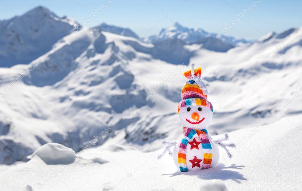 Happy snowman in mountains