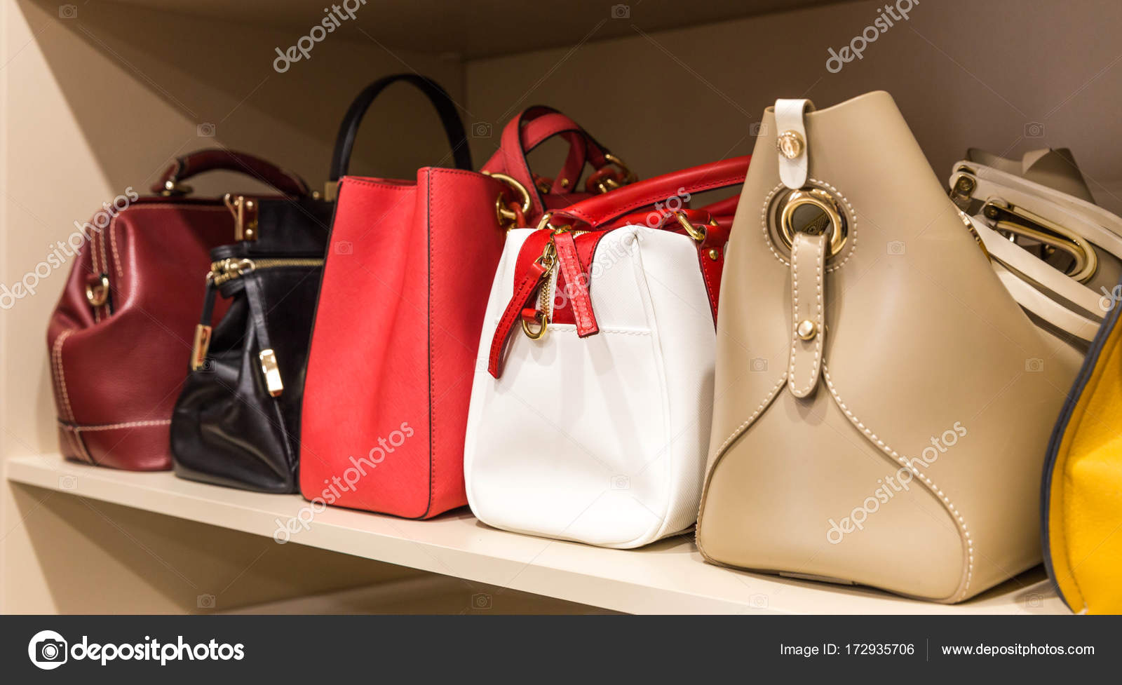 Collection of handbags in woman`s closet Stock Photo by ©mariakray 172935706