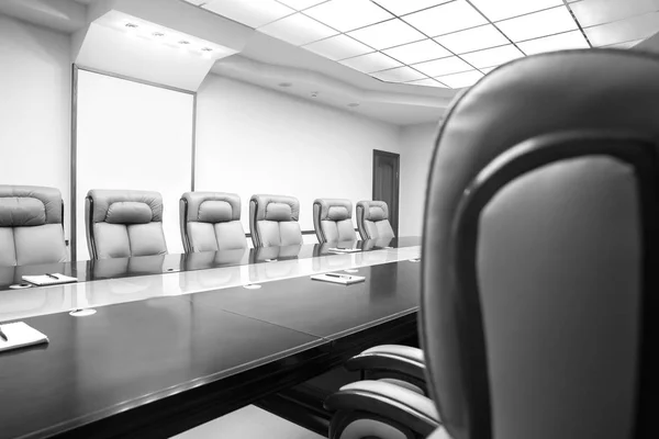 conference room with wooden table and beige leather armchairs