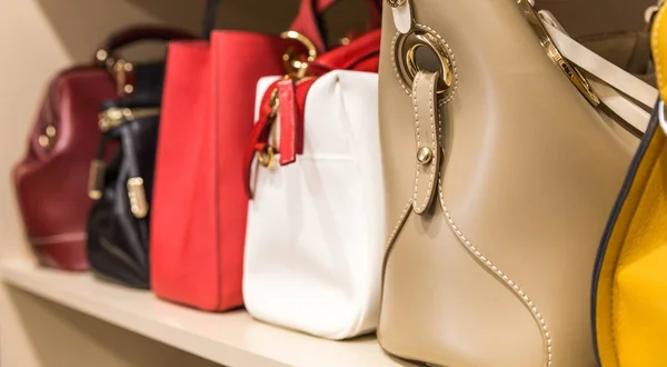 collection of handbags in woman`s closet