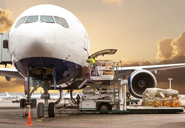 Laden van lading in het vliegtuig op luchthaven, bekijken via venster — Stockfoto