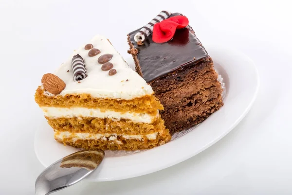 Two pieces of tasty cake on white saucer — Stock Photo, Image